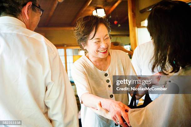 mature japanese female greeting an old friend - japanese greeting stock pictures, royalty-free photos & images