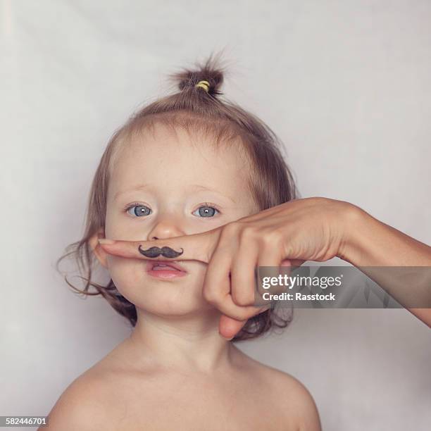 toddler posing with funny hipster mustache - weird baby stock pictures, royalty-free photos & images