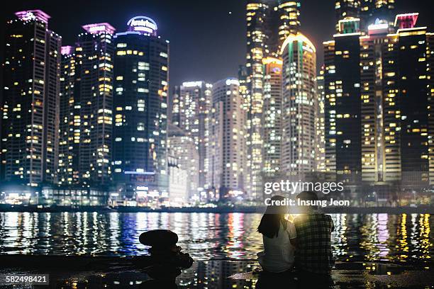 young couple in waterfront park at night - busan stock pictures, royalty-free photos & images