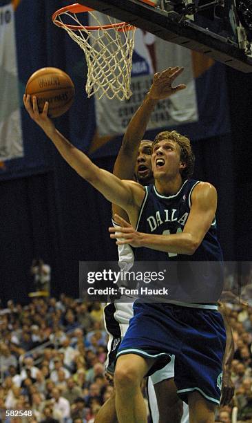 Tim Duncan of the San Antonio Spurs tries to block the shot of Dirk Nowitzki the Dallas Mavericks who scored 42 points during game 5 of the Western...