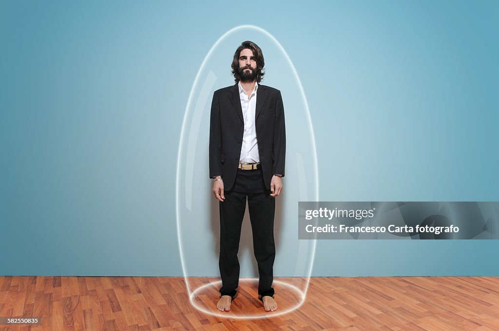 Man inside a large glass test tube