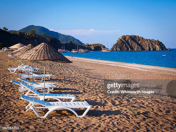 chairs and umbrellas on sandy beach in çirali - kemer stock-fotos und bilder