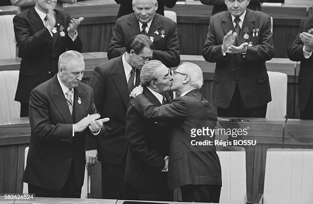 Soviet leader Leonid Brezhnev and East German President Erich Honecker kiss on the occasion of GDR's 30th anniversary.