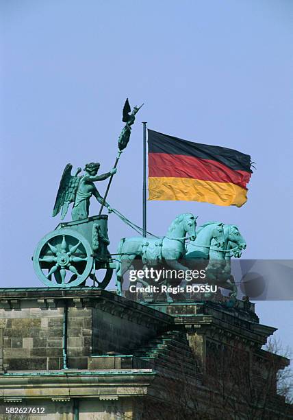 German flag is placed near Johann Gottfried Schadow's sculpture. | Located in: Brandenburg Gate.