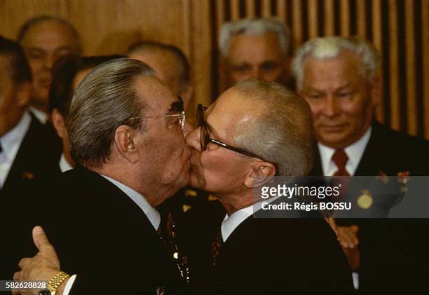 Soviet leader Leonid Brezhnev and East German President Erich Honecker kiss on the occasion of GDR's 30th anniversary.