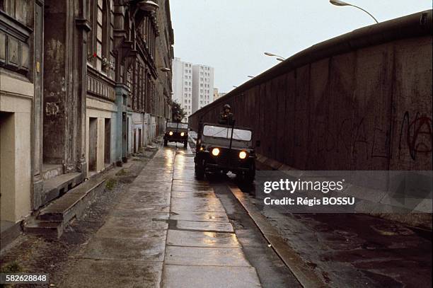 American soldiers patrol along the Berlin Wall, in the Kreuzberg district.