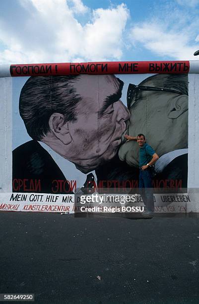 French photographer Regis Bossu in front of the Berlin wall portion named East Side Gallery. He is the author of the famous picture showing Soviet...