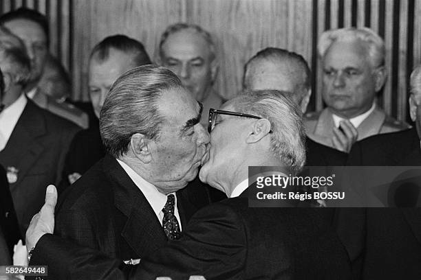 Soviet leader Leonid Brezhnev and East German President Erich Honecker kiss on the occasion of the 30th anniversary of the German Democratic...