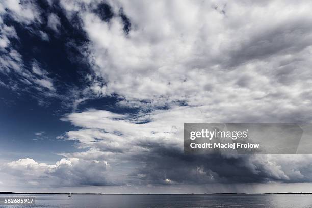 storm cloud above a lake - sniardwy stock pictures, royalty-free photos & images