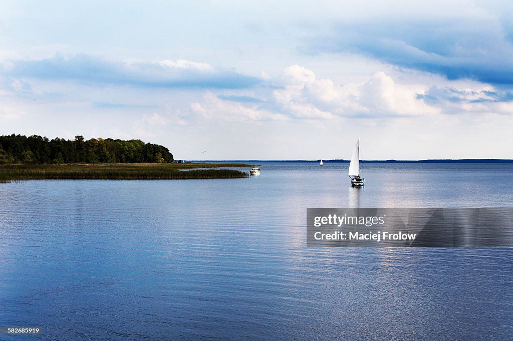 Calm lake and sailboat