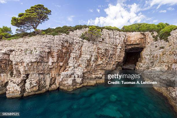 empty sea cave at the lokrum island in croatia - buttress stock pictures, royalty-free photos & images