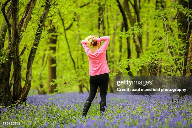 lady holding hair in bluebell wood - bluebell wood fotografías e imágenes de stock