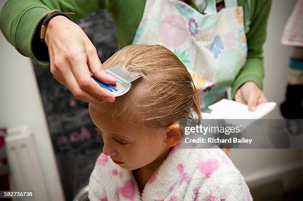 small girl having a nit treatment - louse stock pictures, royalty-free photos & images