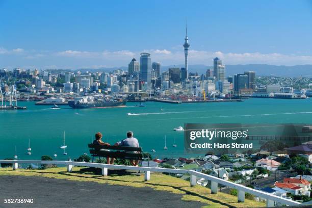 couple looking at downtown auckland - auckland stock pictures, royalty-free photos & images