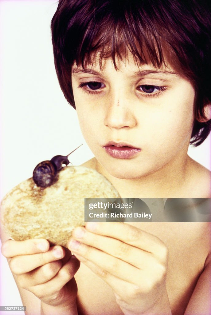 Boy Looking at a Snail