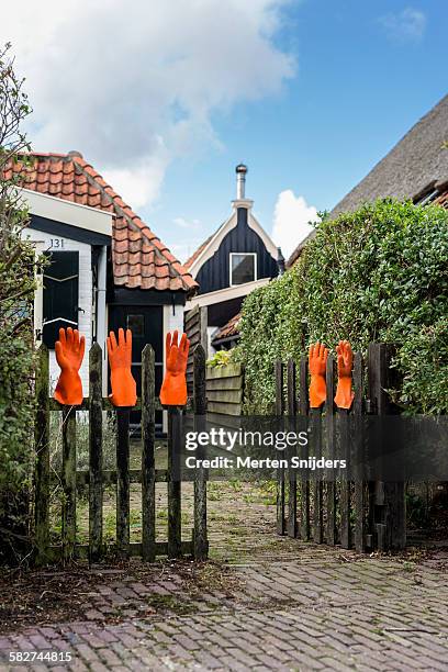 orange handgloves on garden fence - texel bildbanksfoton och bilder