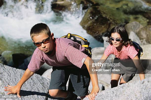 boy and girl scaling rocks - wasatch mountains stock pictures, royalty-free photos & images