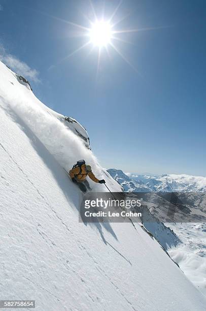 man skiing powder on a steep slope at st. moritz - saint moritz stockfoto's en -beelden