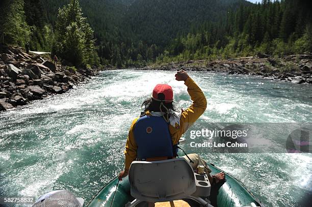 woman having a great time rafting in montana - rafting stock-fotos und bilder