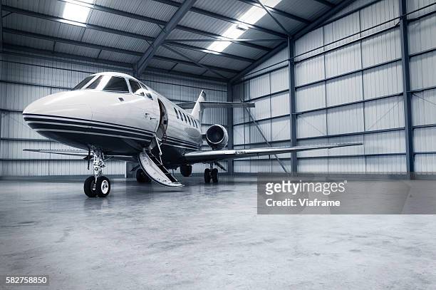 hangar with jet - jets stock pictures, royalty-free photos & images