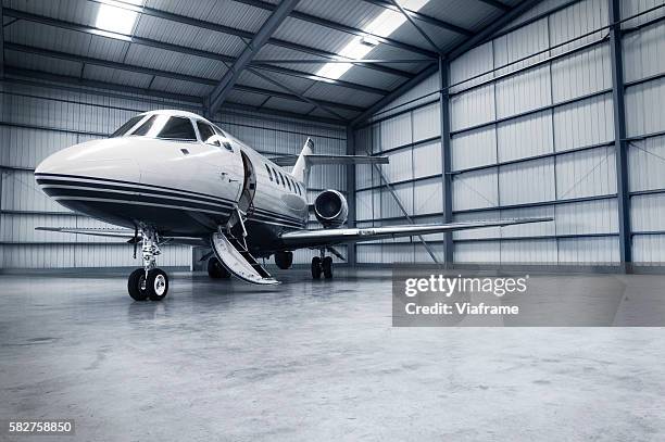 hangar with jet - hanger bildbanksfoton och bilder