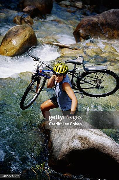 mountain biker crossing river by foot - carrying bike stock pictures, royalty-free photos & images