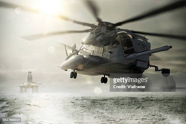 helicopter flying away from oil rig - military rescue stock pictures, royalty-free photos & images