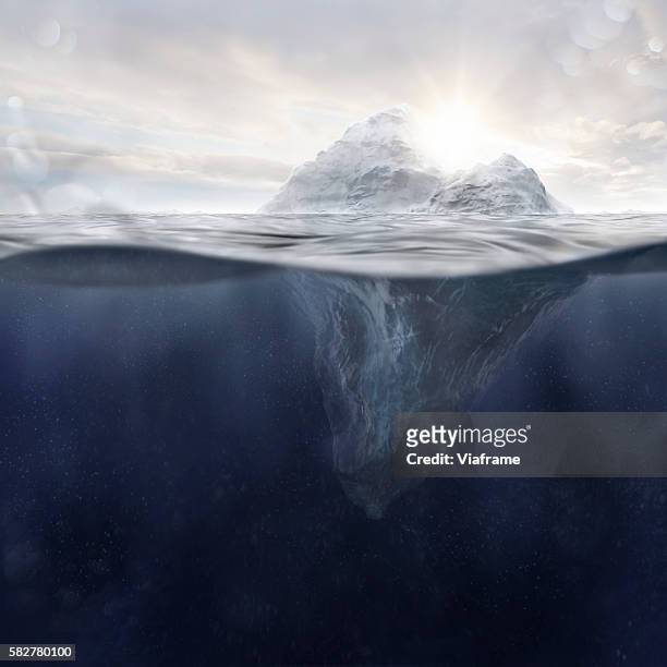 iceberg at sunset and water particles - underwater iceberg stock-fotos und bilder