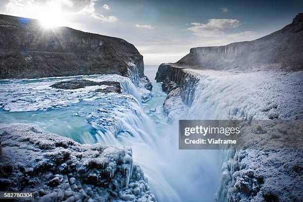 icy canyon with waterfalls - frozen waterfall stock-fotos und bilder