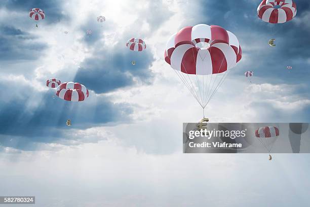 parachutes with euro sign falling from sky - パラシュート ストックフォトと画像