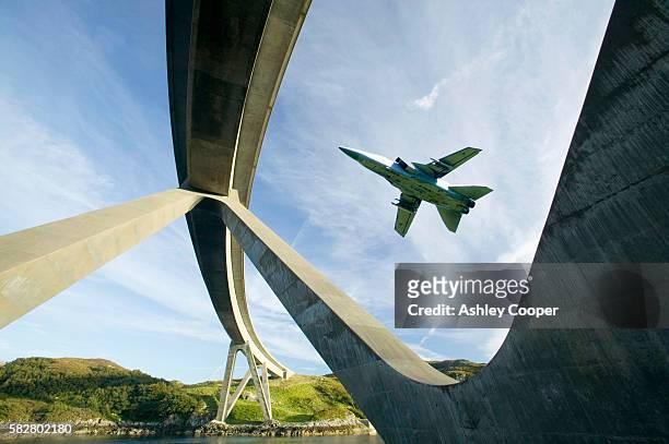 kylesku bridge in assynt scotland uk, with an raf jet flying past. - ejército británico fotografías e imágenes de stock