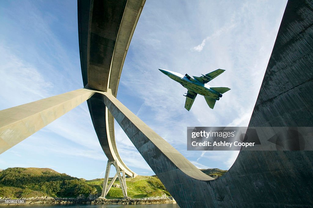 Kylesku Bridge in Assynt Scotland UK, with an RAF jet flying past.