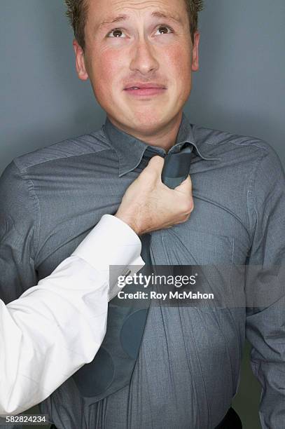 man grabbing another man's collar - dissent collar stock pictures, royalty-free photos & images