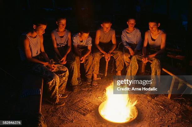 Before going to sleep 'cadets' gathered around the camp fire for some relaxed conversation and quiet inner thoughts. In 1982, facing mounting...