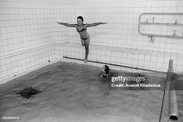 Valia Voronkova, a young Russian girl who lost her leg in the wake of the Chernobyl disaster, balances on a swimming pool bar. On April 26 the fourth...
