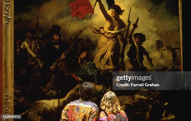 couple viewing liberty leading the people (july 28, 1830) by eugene delacroix - french revolution stock pictures, royalty-free photos & images
