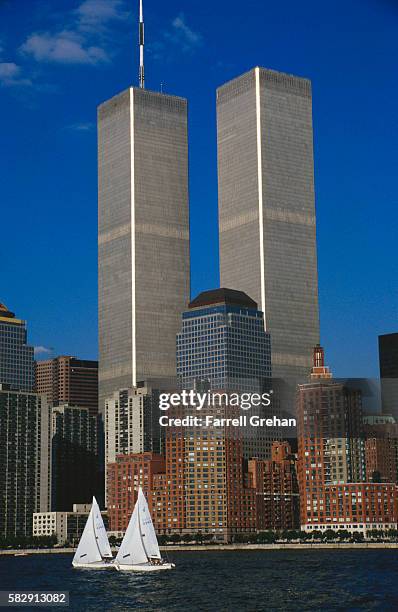 sailboats passing twin towers - farrell grehan stock pictures, royalty-free photos & images