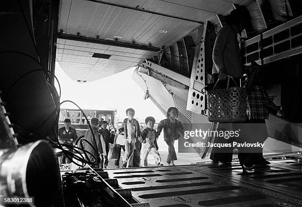 At Tay Son Nhan military airport an empty C-141 aircraft lands to transport refugees every 30 minutes.