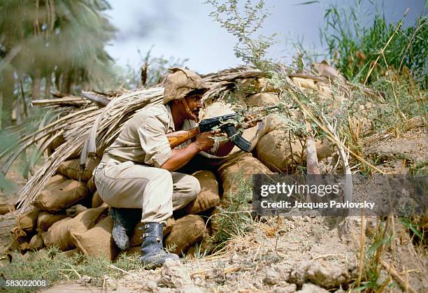 An Iraqi soldier with an assault rifle at the Khoramshar Front in Iran. War broke out between Iran and Iraq in 1980 and lasted until 1988 following...