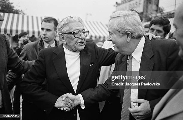 Jean-Marie Le Pen , leader of the extremist right-wing National Front, shakes hands with Roland Gaucher. The men have gathered at the Espace Balard...