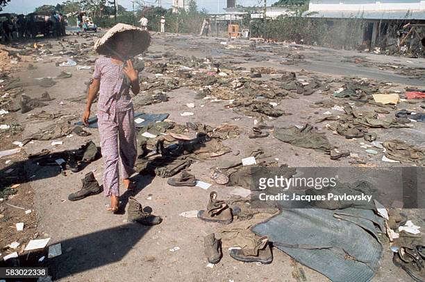 Abandoned uniforms of South Vietnamese soldiers lie on the road after the invasion of North Communist troops which led to the Fall of Saigon.