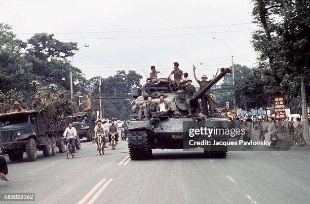 North Vietnamese troops enter Saigon on tanks and trucks, ending the Vietnam War.