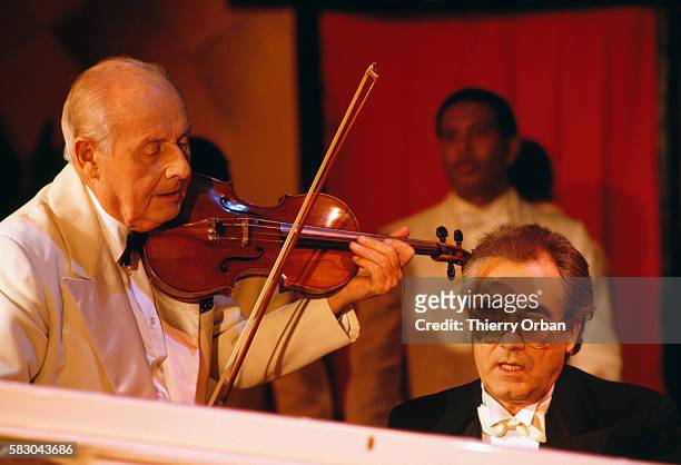Violinist Stephane Grapelli and pianist and composer Michel Legrand on the French musical program Cotton Club.