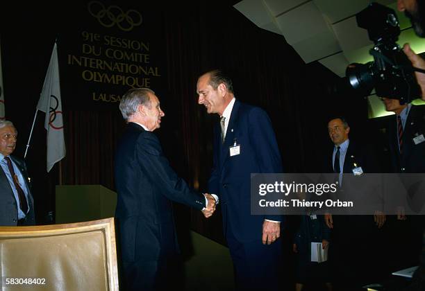 French Prime Minister Jacques Chirac shakes hands with International Olympic Committee president Juan Antonio Samaranch. Chirac was speaking to the...