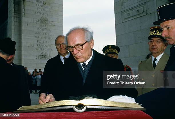 East German President Erich Honeker signs a book at the Tomb of the Unknown Soldier, beneath the Arc de Triomphe de l'Etoile in Paris.