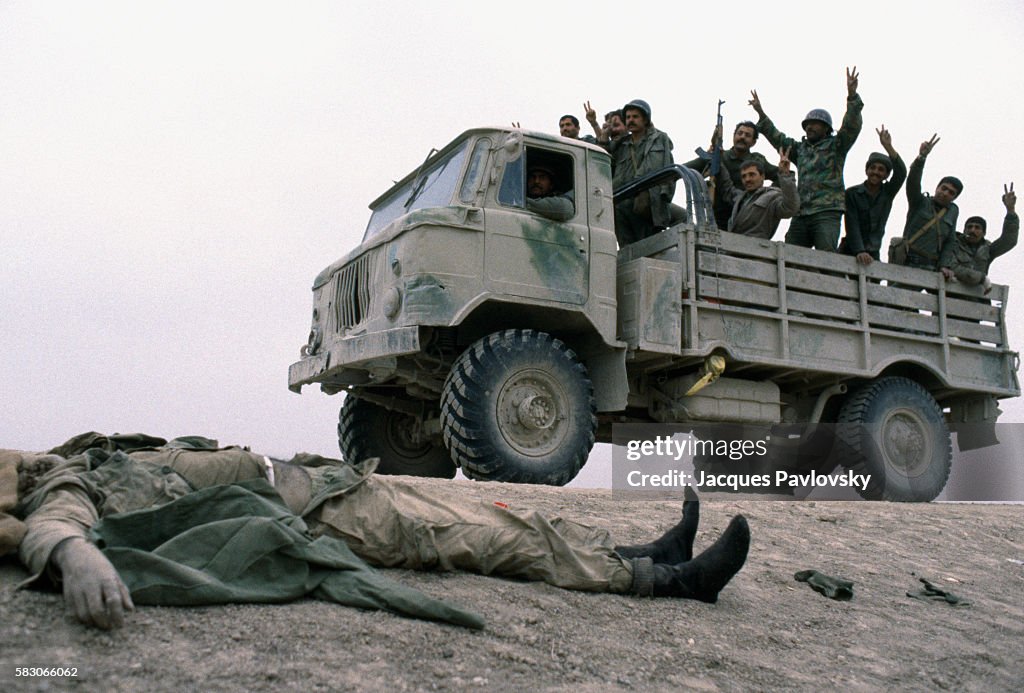 Iraqis Soldiers in Truck Cheering at Iranian Corpse