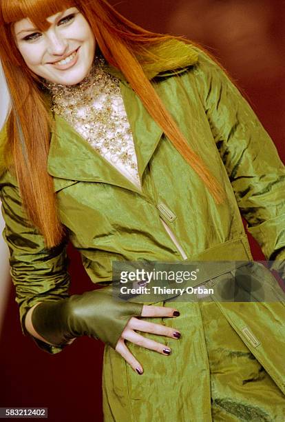 Fashion model wears a Lolita Lempicka Ready-To-Wear women's fashion ensemble during a Fall-Winter 2000-2001 fashion show. The outfit includes a long,...