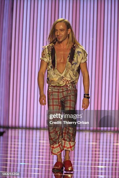 Designer John Galliano shows his women's 2002 spring-summer ready-to-wear line in Paris. Galliano is walking down the runway in plaid pants and an...