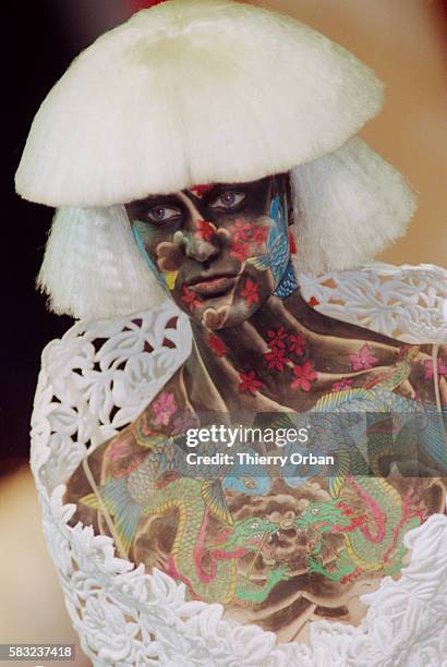 Fashion model wears a Givenchy Haute Couture women's fashion ensemble designed by Alexander McQueen during a Fall-Winter 2000-2001 fashion show. The...
