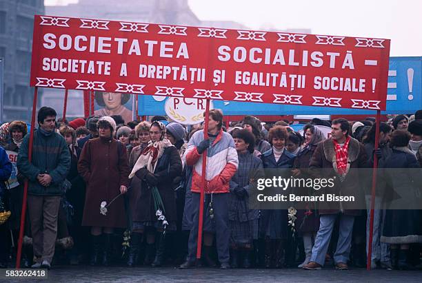 Demonstrators from the Romanian Communist Party hold banners and portraits during a rally in support of President Nicolae Ceausescu in Bucharest, on...